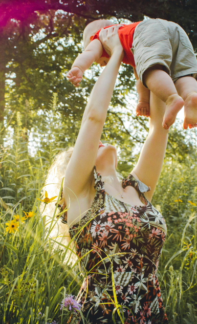 Woman holding her baby up in the air